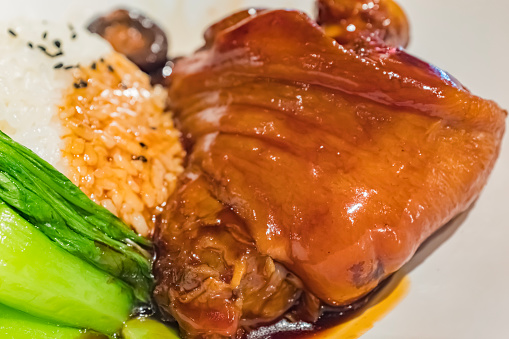 Braised pork belly, close up of stewed pork chop over cooked rice in Taiwan. Taiwanese famous traditional street food delicacy.