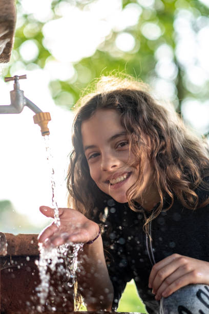istock The little girl drinks water 1431901121