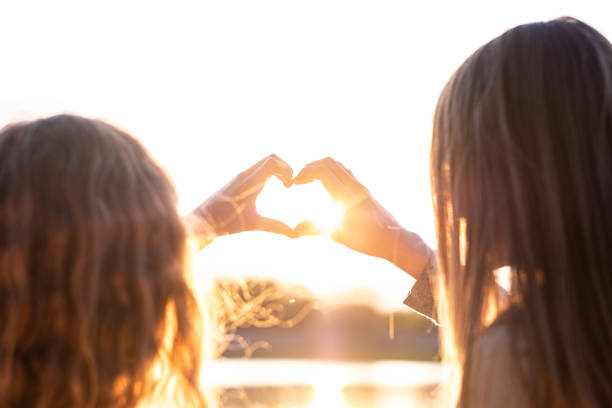 istock Girls holding hands making heart shape 1431901216