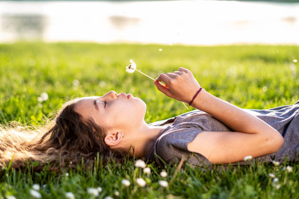 istock A little girl blows a flower 1431901264