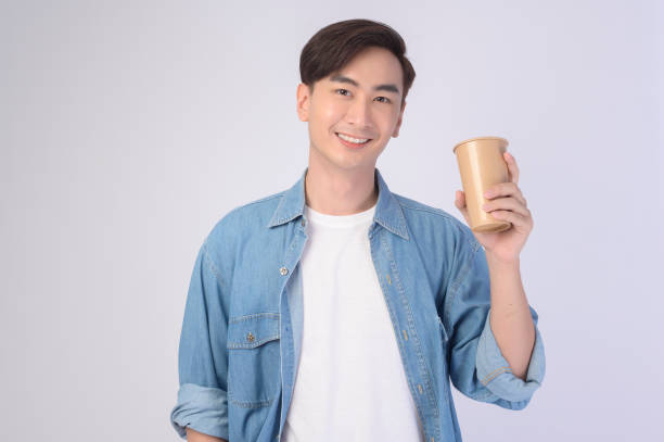 istock Young asian man holding paper cup  over white background, Save earth concept 1431902896