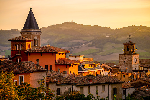 A suggestive sunset light warms the roofs and the skyline of Gualdo Tadino, a medieval town near Gubbio, in the Italian region of Umbria. An important city since Roman times, Gualdo Tadino rises along the ancient consular Via Salaria, traced by the Romans. Its history runs throughout the Middle Ages and, despite having been partially destroyed and sacked numerous times and placed under the dominion of Perugia, this ancient Umbrian center still retains its medieval charm. The Umbria region, considered the green lung of Italy for its wooded mountains, is characterized by a perfect integration between nature and the presence of man, in a context of environmental sustainability and healthy life. In addition to its immense artistic and historical heritage, Umbria is famous for its food and wine production and for the high quality of the olive oil produced in these lands. Image in high definition format.