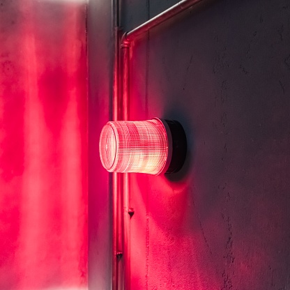 Red warning light on the wall, rotating and flashing