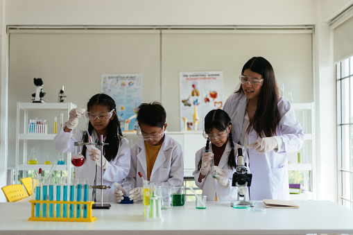Young children working on science experiment with laboratory equipment