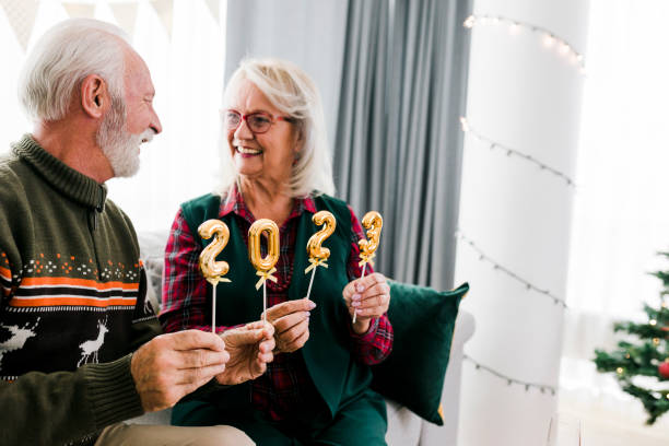 istock Senior couple holding numbers 2023 while celebrating New Year 1431905082
