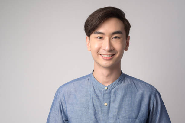 istock Portrait of young asian man over white background studio. 1431905993