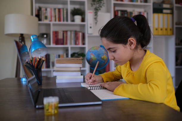 istock Little girl writing her lesson 1431906777