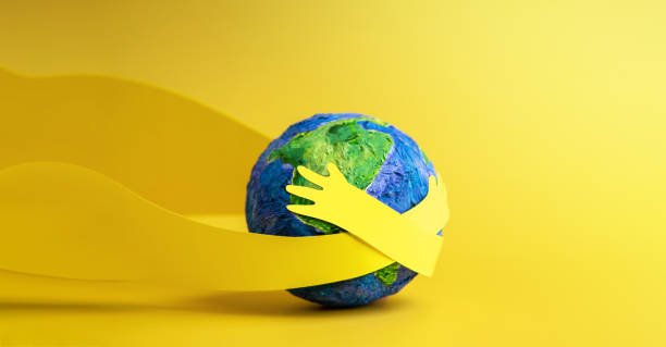 World Earth Day Concept. Green Energy, ESG, Renewable and Sustainable Resources. Environmental Care. Paper Cut as Hands Embracing Green Globe. Top View stock photo