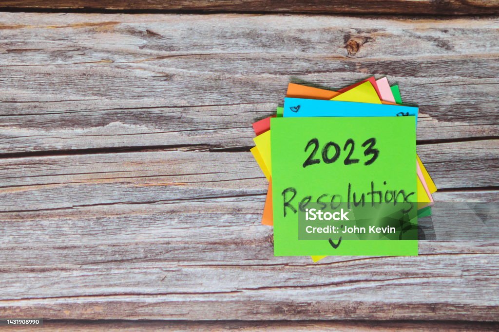 New year 2023 goals, resolutions and bucket list concept. Colorful sticky notes on wood background. New Year Resolution Stock Photo
