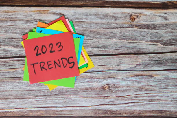istock New year 2023 new trends concept. Colorful sticky notes on wood background. 1431908996