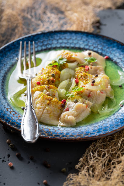 istock Healthy marinated herring on blue plate and fishing net. 1431909400