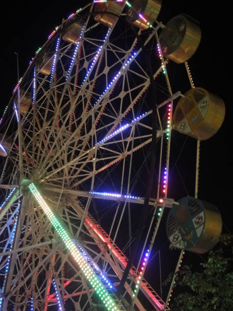 istock Ferris wheel that emits colorful lights at night 1431910792