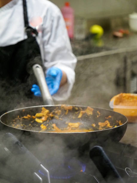 istock chef cooking sauce in a pan in professional restaurant catering kitchen 1431910800