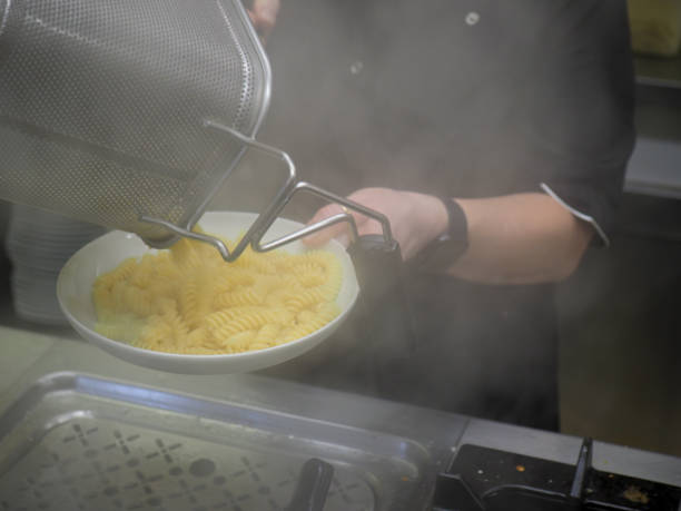 istock chef cooking pasta in professional kitchen boiler in a restaurant 1431910906