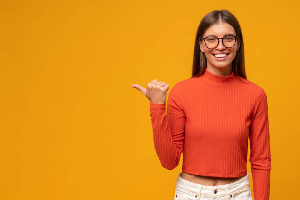 istock Young woman pointing to the side, showing copy space for offer 1431911038