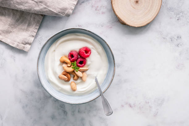 istock Bowl of yoghurt with a silver spoon 1431912353