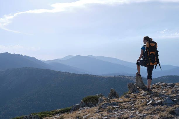 istock A Female traveler with backpack admiring mountains 1431912398