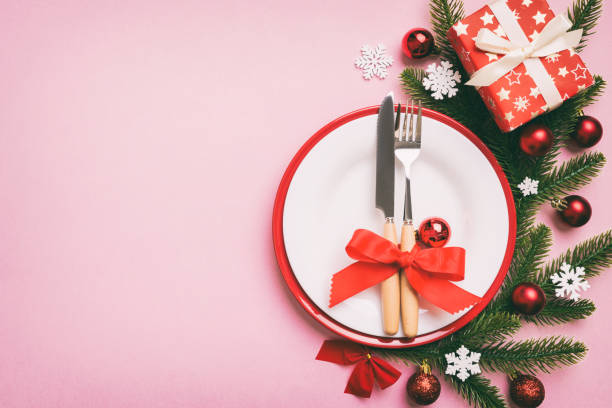 istock Christmas table place setting with christmas decor and plates, kine, fork and spoon. Christmas holiday background. Top view with copy space 1431913540