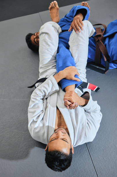istock Fitness, exercise or training with an mma or karate student and teacher learning and exercising in a workout in a gym or health studio from above. Sport, wellness and fighting with a fight instructor 1431913714