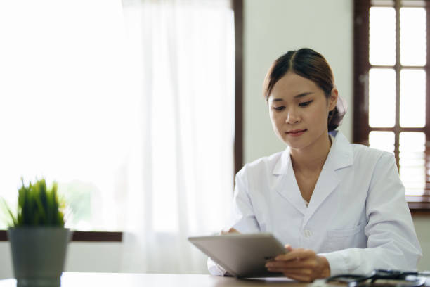 istock An Asian female doctor is using a tablet computer to analyze patient symptoms before treatment 1431914133