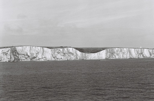 Black and white 35mm photo of the White Cliffs of Dover seen from the sea.