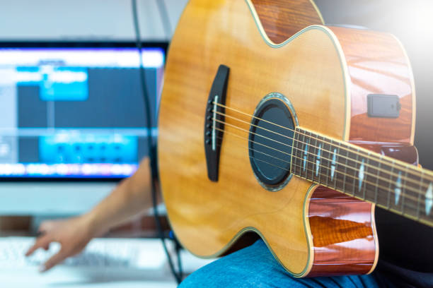 istock man hand acoustic guitar home studio 1431915687