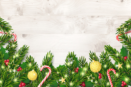 Christmas and New Year background with fir branches and red berries on rustic wooden planks