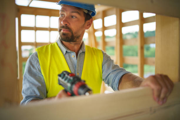 istock Construction worker working with electric screwdriver on wooden frame, diy eco-friendly homes concept. 1431916912