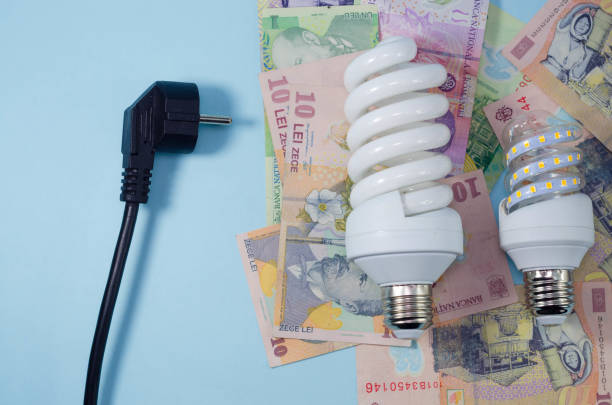 istock Light bulb, romanian ron banknotes and black power plug over blue background. Concept of increasing the electricity costs due to power crisis and inflation. Rising energy costs. 1431918576