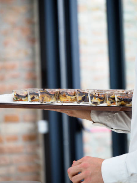 istock waiter serving luxury finger food in event buffet - catering staff at work 1431919610
