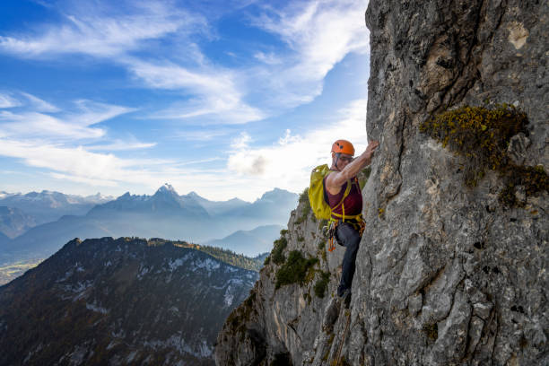 istock Rock climbing in Alps - man climbing in the alps 1431921550