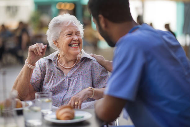 istock Caregiver having breakfast with his client at cafe. 1431924786