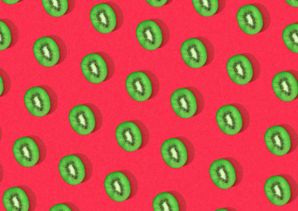 istock Halved kiwi fruits in mesh pattern over red background 1431926386