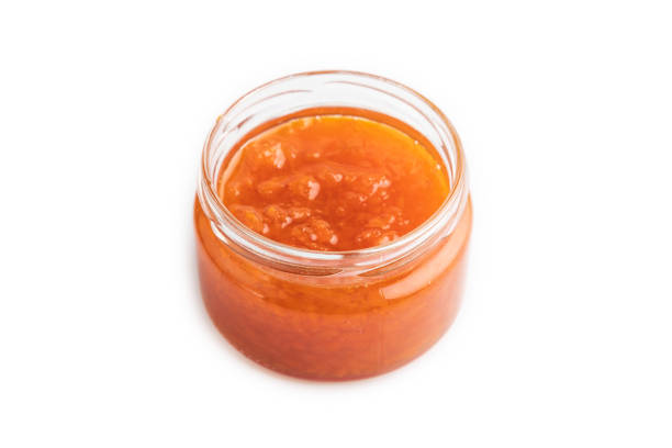 istock Carrot jam with cinnamon in glass jar isolated on white. Side view. 1431926994