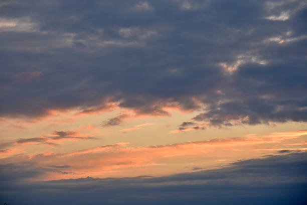istock Sunset sky with pink and blue clouds in summer. Beautiful sunset with the sun. 1431927185