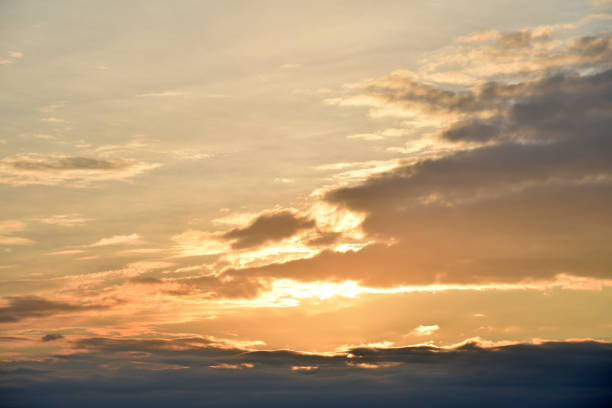 istock Sunset sky with pink and blue clouds in summer. Beautiful sunset with the sun. 1431927189