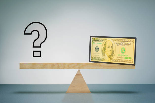 istock Question mark and bill dollar on scale board. What currency will be the world currency. 1431927812