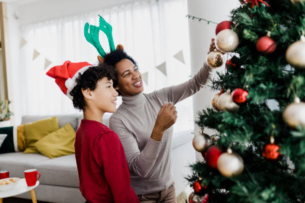 istock Boy decorating Christmas tree with his mother 1431928558