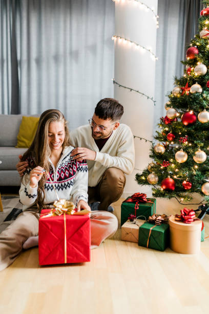 istock Man giving a Christmas present to his girlfriend at home 1431930218