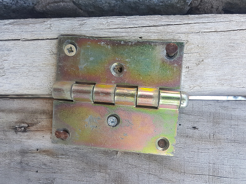 detail of a hinge on a wooden gate