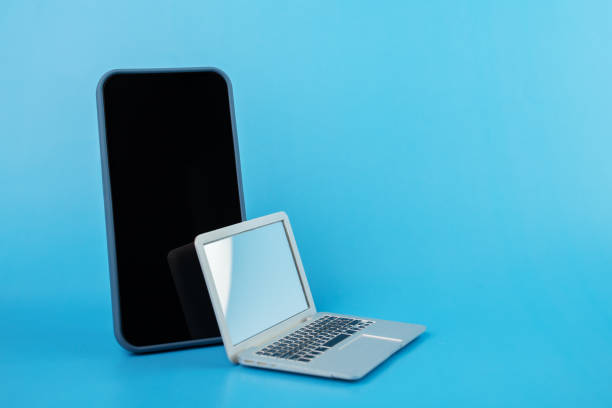 istock mobile application, black Friday, sale and discount, phone and laptop on blue background, copy space 1431932255