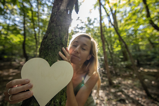 Woman giving love to the forest