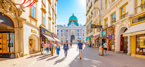 Shopping Kohlmarkt street and Hofburg Palace in Vienna old town, Austria Vienna, Austria - 26 May, 2022: Famous shopping Kohlmarkt street with many luxury brand stores, Hofburg palace on a background kohlmarkt street photos stock pictures, royalty-free photos & images