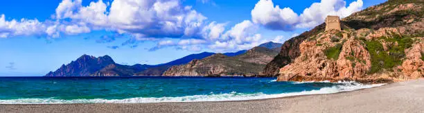 Photo of Corsica island nature landscape. Gulf of Porto.  beach of Porto Ota, panoramic view with island and Genoan tower monument.