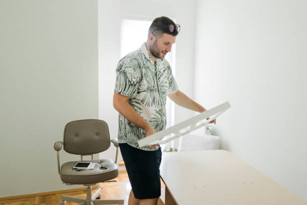 istock A young man is assembling an office desk in his new home 1431937647