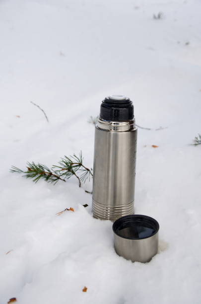 istock Winter tourism. Thermos in the snow. 1431940946