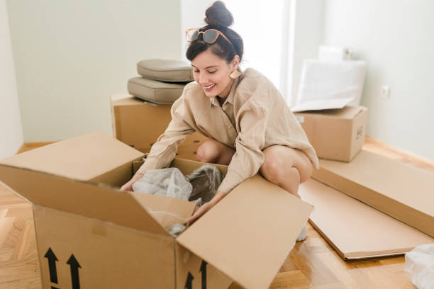 istock One woman, young lady moved into her new apartment, unpacking boxes alone. 1431940977