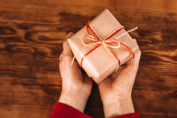 istock Woman Holding A Christmas Present 1431943115