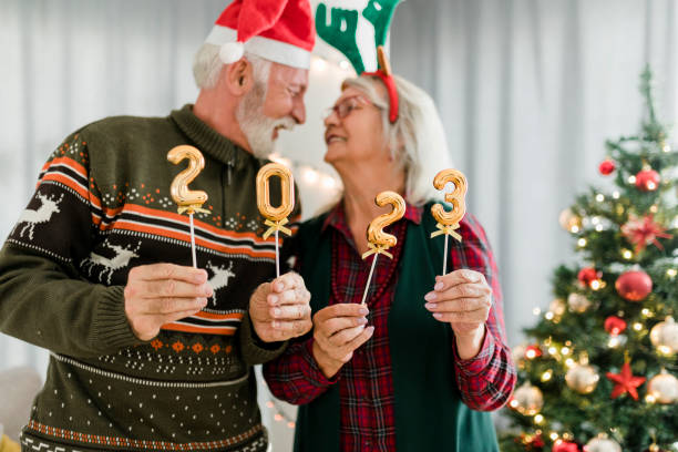 istock Senior couple holding numbers 2023 while celebrating New Year 1431943120