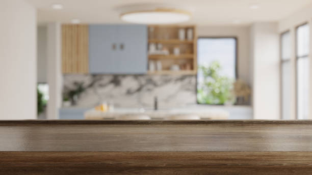 istock Wooden table top on blur kitchen room background,Modern kitchen room interior. 1431943305